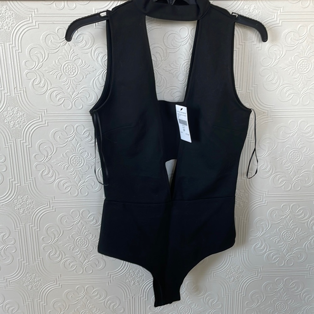 NWT sexy black with cut outs bodysuit, thick material (not a lot of stretch)